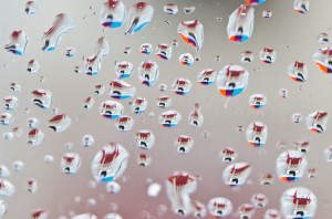 water droplets on a glass with a colourful background